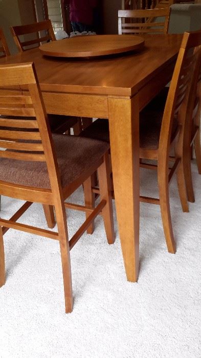 PUB DINING TABLE WITH 6 CHAIRS AND A LAZY SUSAN, AND 2 SELF STORING LEAVES.