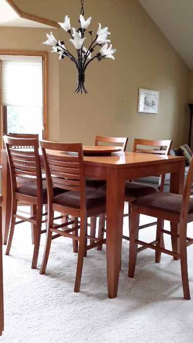 PUB DINING TABLE WITH 6 CHAIRS AND A LAZY SUSAN, AND 2 SELF STORING LEAVES.