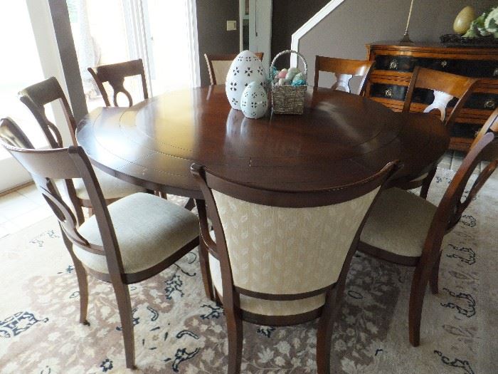 This is the most amazing custom made table with the leaves added at the outside of the table so it continues to be a round table from 52" to 76"--Beautiful!  It includes 6 custom side chairs and 2 captain chairs.