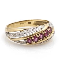 14K Two-Tone Gold Diamond and Ruby Ring: A 14K two-tone gold ruby and diamond ring. This ring features a line of five prong set rubies in yellow gold and eight set diamonds in white gold accents with a swirled, diagonal design.