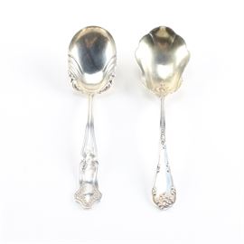 Towle "Rustic" and James E. Blake Co. Sterling Sugar Spoons: A pairing of sterling silver sugar spoons. This includes a spoon in the Rustic pattern by Towle Silversmiths and a spoon by James E. Blake Co. with a foliate embellished handle. The total approximate weight is 1.060 ozt.