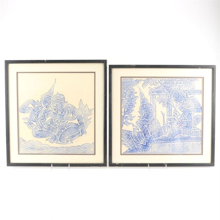 Thai Rubbings: A set of Thai rubbings. This set features two rubbings depicting figures in blue on a beige paper. Each piece is presented behind a cream mat with a black liner under glass in a black painted wood frame with a wire on the back for hanging.