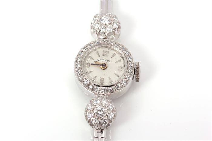 Croton 14K White Gold 0.68 CTW Diamond Watch: A Croton white gold watch with a diamond halo border and diamond clusters to the white gold chain link band.