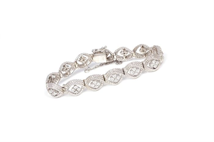 14K White Gold 1.60 CTW Diamond Bracelet: A white gold bracelet is formed by twisted rope chain links accented by four round cut diamonds to the center of each.
