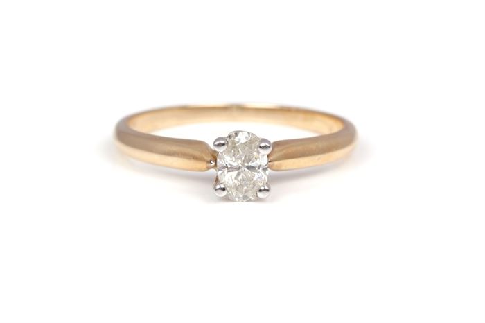 14K Yellow Gold 0.50 CT Diamond Solitaire Ring: A yellow gold shank with oval faceted prong set diamond to the center.