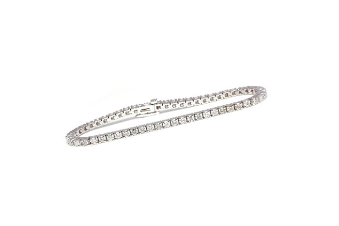 14K White Gold 4.36 CTW Diamond Bracelet: A white gold line bracelet with round cut basket prong set diamonds mounted side by side. The bracelet is in excellent condition and has not been worn.