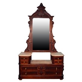Antique Victorian Eastlake Style Walnut Dresser With Mirror: An antique Victorian Eastlake style dresser. Made of walnut, the dresser comes with a mirror that is flanked by two small shelves. The dresser has three marble tops, six drawers with dovetailed construction, and brass drop-down drawer pulls with wooden accents. The piece is unmarked.