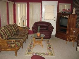 Vintage rattan sofa and end tables. Oak t v armoire.