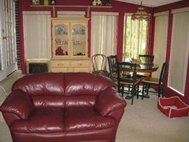 Love seat, Glass top table and four chairs, Painted cabinet with glass doors.