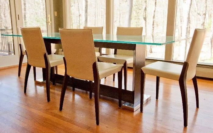Glass top dining table, with wood and metal base. Table measures 94.5" long, 39.5" wide. Six Cattelan Italia leather Arcadia chairs. 