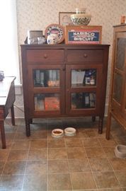 American Antique Kitchen Cabinet featuring pull out drawers and glass cabinet doors and side metal designs 