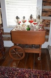 Vintage Tea Cart on Wheels with Drop Leaf Sides plus part of the Oil Lamp Collection with more on the underneath shelf