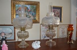 Gorgeous Alladin Lamps with different Bases but Matching Lincoln Drape Shades, also Hand Blown Flower Vase and Oil Paintings in background