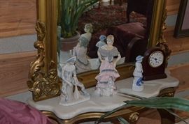 Signed and numbered figurines & small clock displayed on marble shelf of Rocco Wall Mirror 