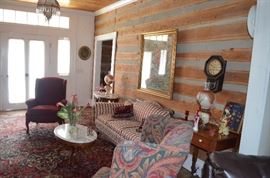 View of the Beautiful Living Room of this Historic Home featuring Wing Back Chairs, Victorian Sofa, Marble Top Tables, Gone with the Wind style Lamps, Regulator Clock, etc