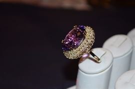 #6. Gorgeous Ameythyst & Diamond Ring Ladies 14k yellow gold Oval Style Ring Mounting weighing approx. 10.83dwt and is set in center with one Oval Cut Amethyst measuring approx. 23.2mm in length by approx. 17mm in width by approx. 12.3mm in depth and weighs approx. 26.45ct. Set around the center is 32 Round Brilliant Diamonds totaling 96/100ct. the color is H-J and clarity is SI(1) - SI(2) Total approx. weight of all Diamonds is 2.58ct