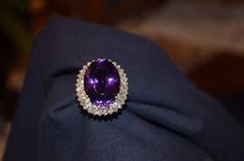 #6. Gorgeous Ameythyst & Diamond Ring Ladies 14k yellow gold Oval Style Ring Mounting weighing approx. 10.83dwt and is set in center with one Oval Cut Amethyst measuring approx. 23.2mm in length by approx. 17mm in width by approx. 12.3mm in depth and weighs approx. 26.45ct. Set around the center is 32 Round Brilliant Diamonds totaling 96/100ct. the color is H-J and clarity is SI(1) - SI(2) Total approx. weight of all Diamonds is 2.58ct