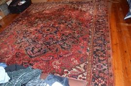 Another Gorgeous Antique Rug in the Historic Home. There are 3 9' x 12' Bakhtiari Rugs all with cloth tags made in Iran and one smaller Bakhtiari approx. 3' x 9'.