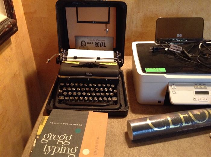 Royal Quiet De Luxe model portable typewriter with case and books.