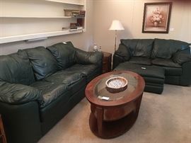 Green leather couch and loveseat