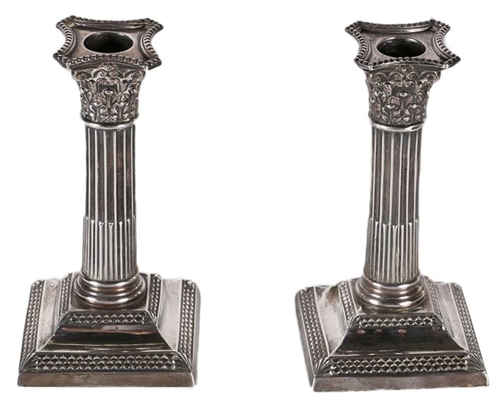 1897 Thomas Bradbury & Sons Weighted Sterling Silver Candlesticks: A pair of antique sterling silver candlesticks. This lot includes an 1897 pair by London silversmiths Thomas Bradbury & Sons. They are in the form of corinthian columns, with an acanthus leaf capitals and fluted shafts. The hallmarks for Thomas Bradley and London are located along the bases, and along the undersides are pieces of weighted metal.