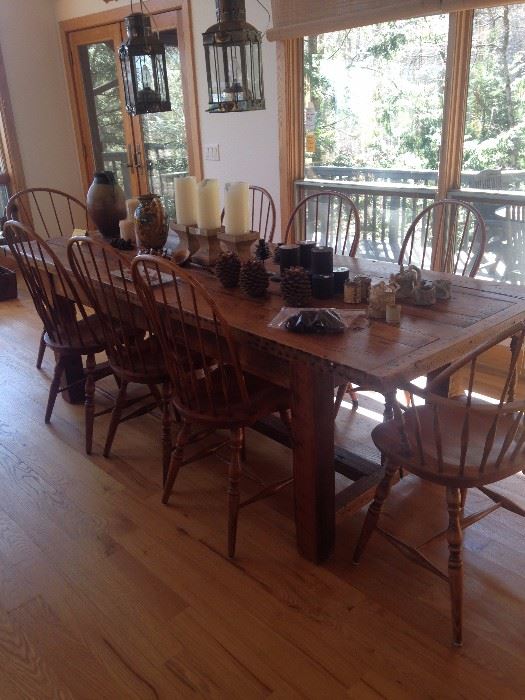 Custom made pine harvest table with stretcher base - 8 ft. 2 in. long X 36 in. wide.  Set of Eight, Made in Slovania Windsor style chairs - 2 with arms and 6 armless. Pottery and decorator items. 