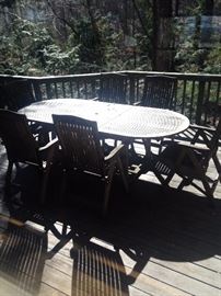 oval wood patio table with six arm chairs.