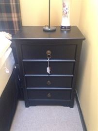One of a pair of small chests used as bedside stands.