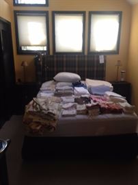 Queen size bed with custom made head board with "scottish" plaid fabric.  Vintage linens, some new and new and gently used bedding and linens.