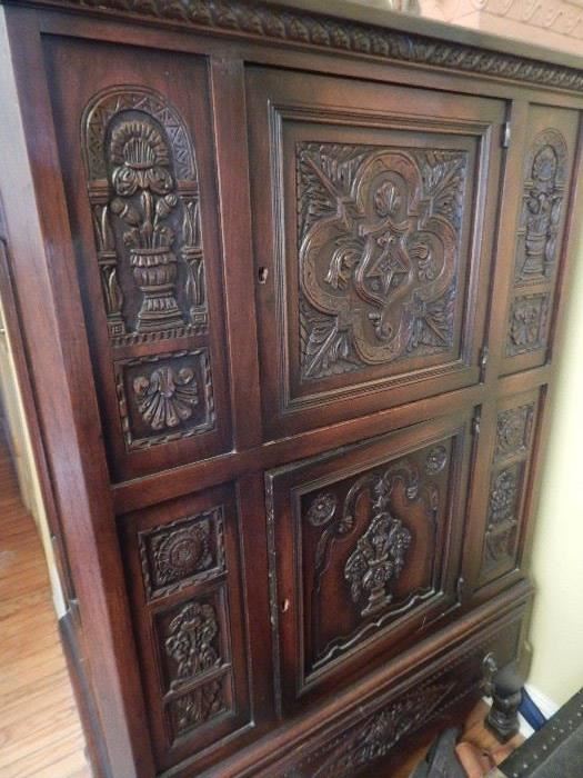 Lovely old antique cabinet with lots of carvings on the front.