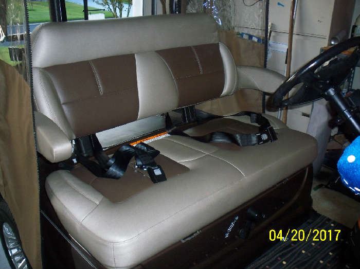 This golf cart comes equipped with seat belts and arm rests.