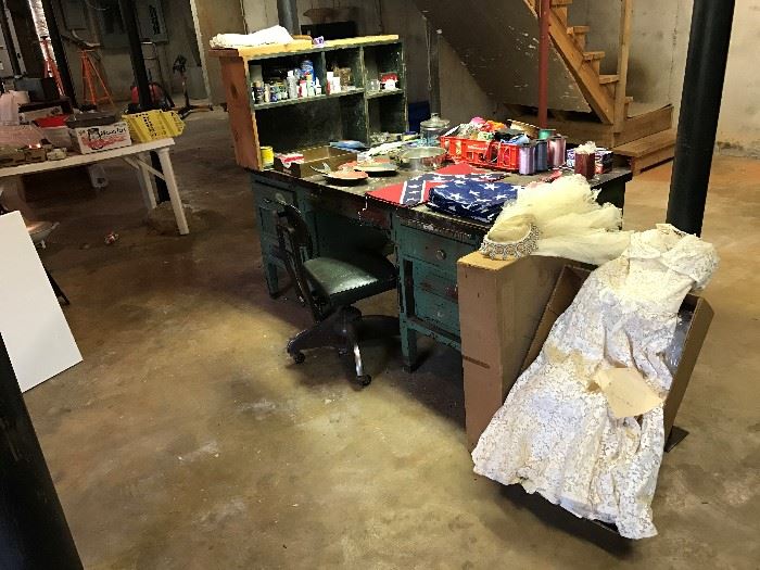 Vintage wedding dress.  Old office desk, painting supplies, ribbons, and just stuff.