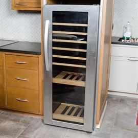 Electrolux Icon Wine Cooler: An Electrolux Icon wine cooler. Bottles are visible through the door of this cooler with eight shelves. The stainless steel item is marked with model number E24WC160ES. The appliance was not tested.