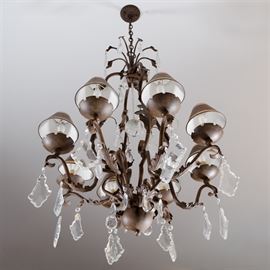 Eight Arm Metal and Glass Chandelier: An eight arm metal and glass chandelier. This piece features a bronze-tone metal base and arms with foliate sprays. Glass prisms hang from the arms, and acanthus accents. The light was not tested.