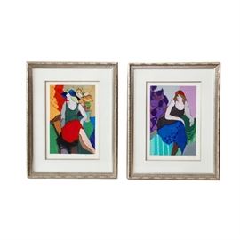 Itzchak Tarkay Signed Limited Edition Serigraph Portraits: A pair of limited edition serigraphs by Itzchak Tarkay (1935-2012). These abstract works depict portraits of women lounging in different settings. These pieces are signed by the artist to the lower right and are numbered 157 in an edition of 300. They are presented behind white mat behind glass in a silver painted wood frame with a wire on the back for hanging.