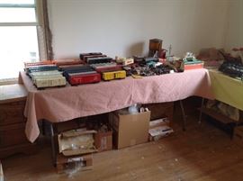 Operating milk car, rr crossing house, train car parts, flatcar loader with white box, tender, caboose, box cars,