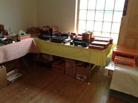 Shot of Lionel trains on the table....has Gate, signal bridge, auto loader, passenger card, dome car, ice car, box car flat car with boat, water towers, icing stations etc