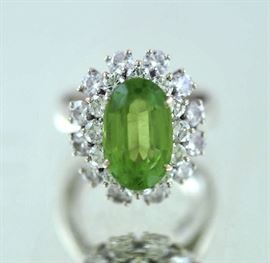 Lot 4: Ballerina style ring in (tested) 14kt white gold set w/approx. 3.84 ct light yellowish green oval tourmaline and approx. 2.0 ct tw round brilliant cut’s, 18 mm wide, size 5.5, 6.8 grams