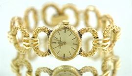 Lot 171: 14k yellow gold Baume & Mercier ladies wrist watch with gold band, 46.4 grams