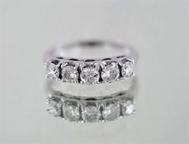 Lot 284: 14k white gold and diamond band, five diamonds approx. 1 ctw