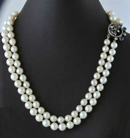 Lot 379: Double strand pearl necklace 7.75mm 15"L. with diamond and emerald clasp