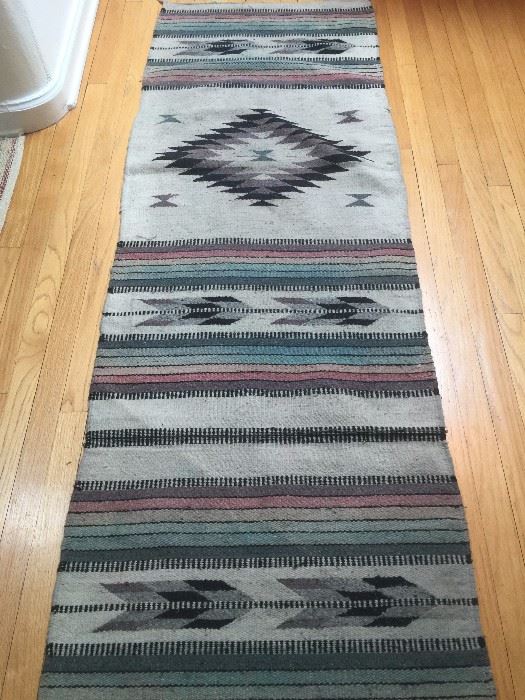 Large collection of Navajo rugs dating from late 1800's to mid century, including "dazzler" and "pictorial" rugs, some with authentication certificates