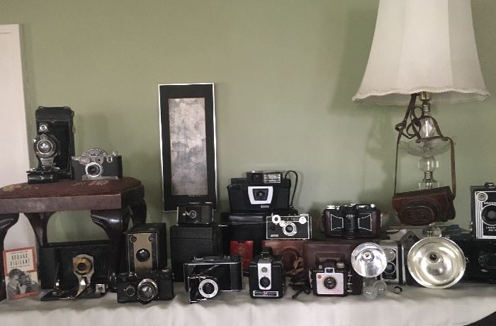 Quite the collection of vintage cameras - many in good working condition, and all great vintage decore
