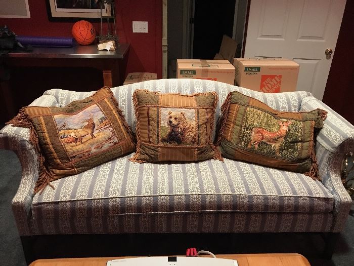 Curved  couch and needlepoint pillows