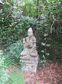 Concrete/Limestone   Buddah. Stands about 5 feet tall. The fence behind the statue is also for sale