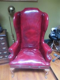 Pair of red leather wing chairs, both have nail head trim