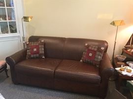J C Penney brown leather couch with double bed sleeper