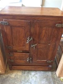 32.5 W x 16 D x 43 H, this beautiful rare, early antique three door ice box. Original hardware and markings on the back. Comes with three wire shelves and drainage on lower part. 4 rollers on bottom of cabinet.
