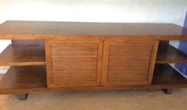 Maria Yee Media Console.70 in L x 20 D x 24.5 H, a very modern media cabinet. 2 sliding doors that can close in the middle or be pulled to either side. Contemporary vibe with a rustic feel. Great condition with no flaws. This designer uses only the top products on all her designs. This is a high end hand crafted item.