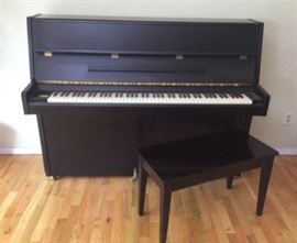 Yamaha Upright Piano and Bench.59 L x 23 D x 46 H, bench 30 L x 14 D x 19 H, this ebony piano has very modern lines. Numbered E3511129. Good condition, most likely needs to be tuned. Bench has storage.